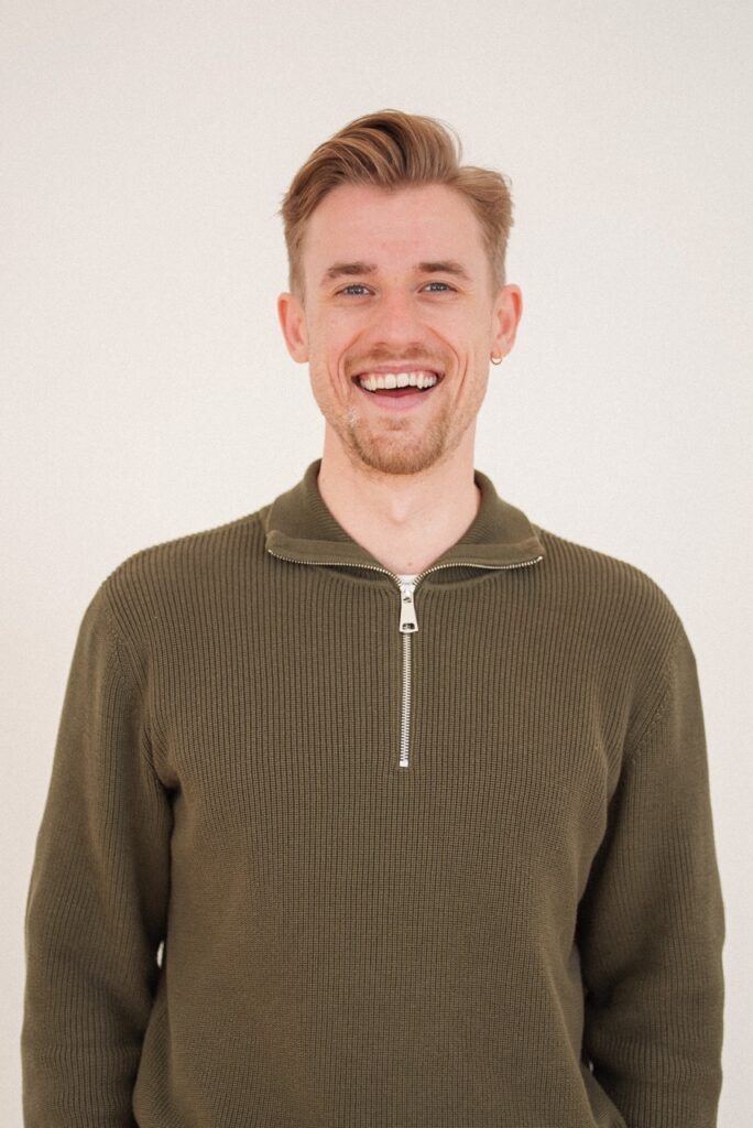 A professional headshot of Lasse Finderup, CEO of Good Tape, smiling and looking directly at the camera in a bright, modern office setting.